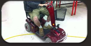 Who is driving the mobility scooter?